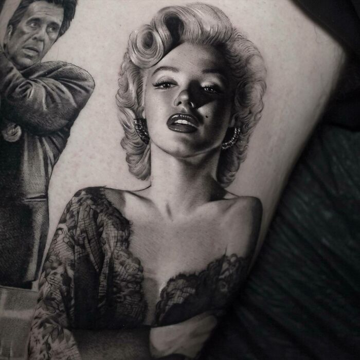 Realistic tattoo of iconic figures showcasing detailed artistry.