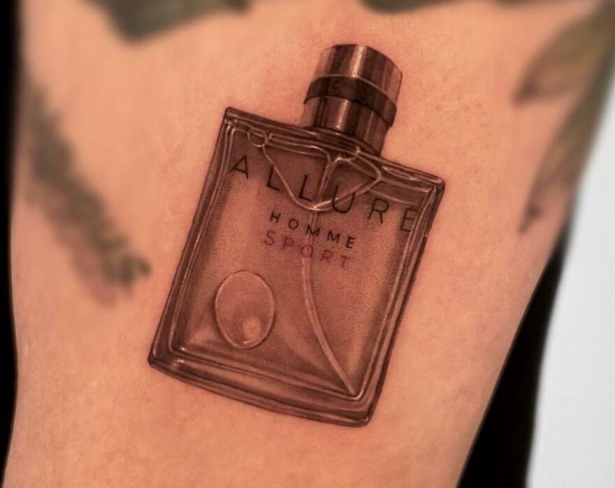Realistic tattoo of a perfume bottle on skin, showcasing flawless artistic detail.