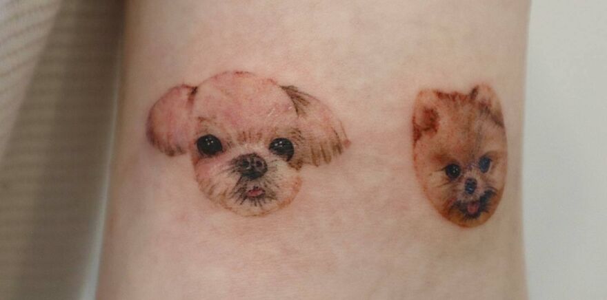 Realistic tattoos of two dog faces on skin, showcasing detailed artistry in tattoo design.