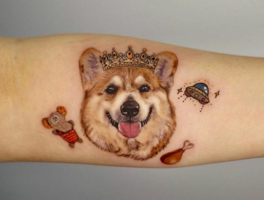 Realistic tattoo of a crowned corgi with playful elements, showcasing stunning detail.