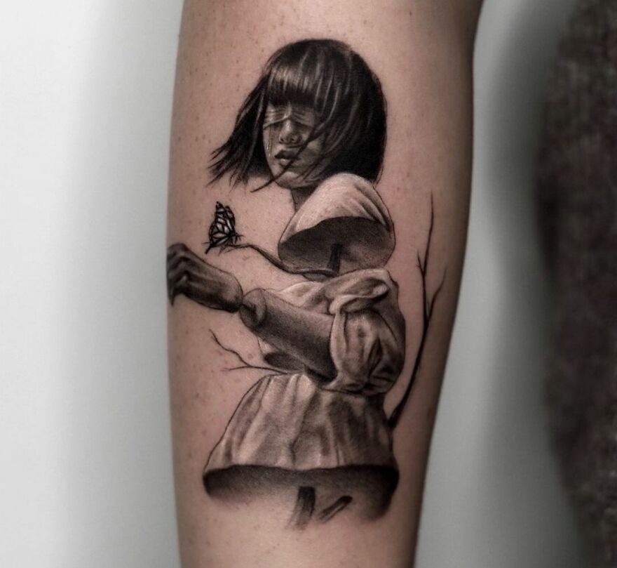 Realistic tattoo of a short-haired girl with eyes closed, cut into three pieces on forearm.