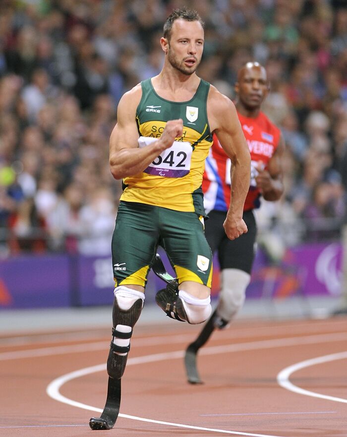 Athlete in a race, wearing green and yellow, symbolizing celebrities who went to jail.