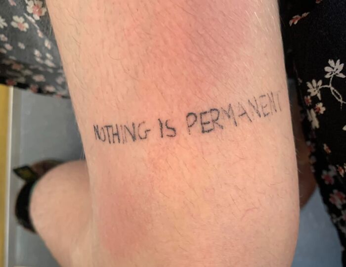 Bad tattoo reads "Nothing is permanent" on skin, illustrating humorous inkshaming.