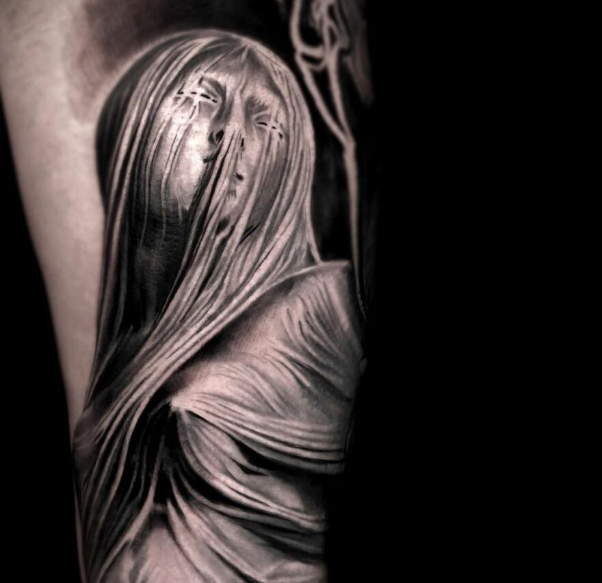Realistic tattoo of a veiled woman with intricate shading, blending art and reality flawlessly.