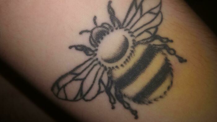 Bee tattoo on forearm, showcasing perfect matching with natural skin tones.