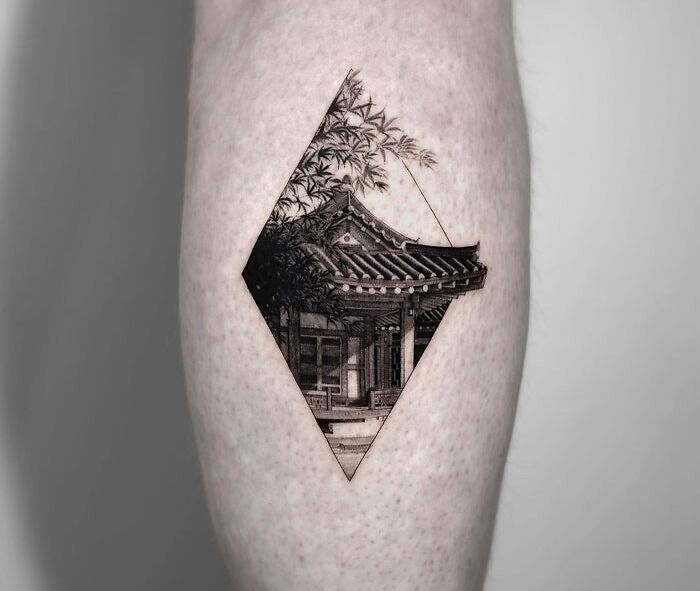 Calf tattoo featuring a detailed, geometrical design of a traditional Asian building.