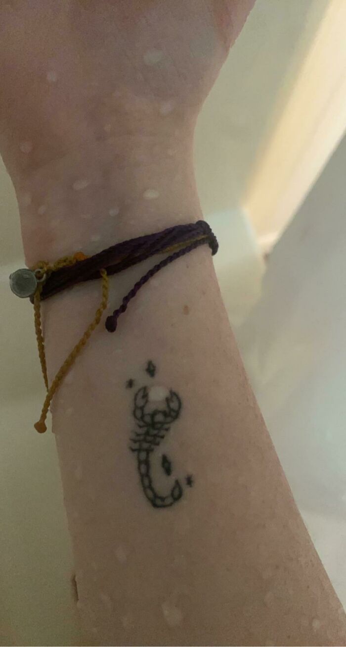 Close-up of a scorpion tattoo on a forearm with bracelets, highlighting tattoos that match perfectly with situations.