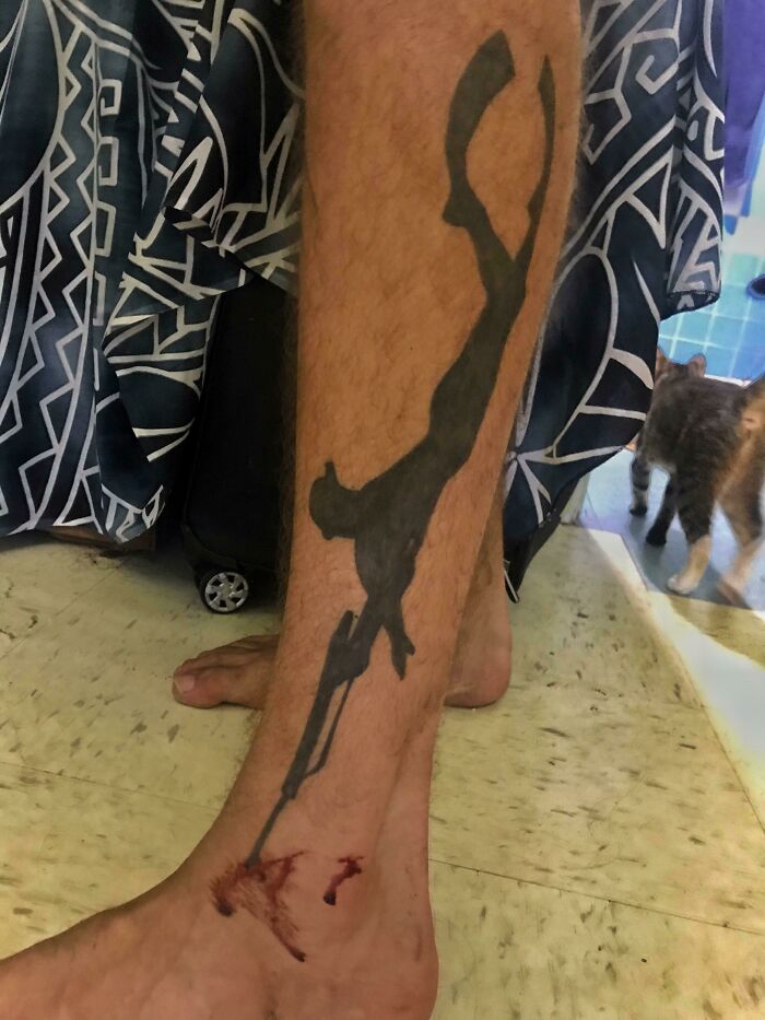 Tattoo of diver on leg with injury, creating a perfect accidental match with the situation.
