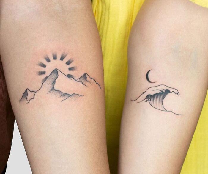 Matching tattoos of a mountain with sun and a wave with a moon, symbolizing connection for couples or special people.
