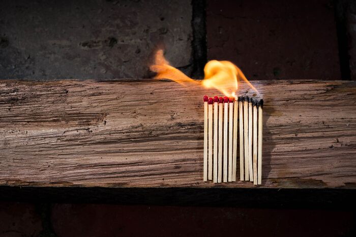 Matches on wood and half of them are on fire