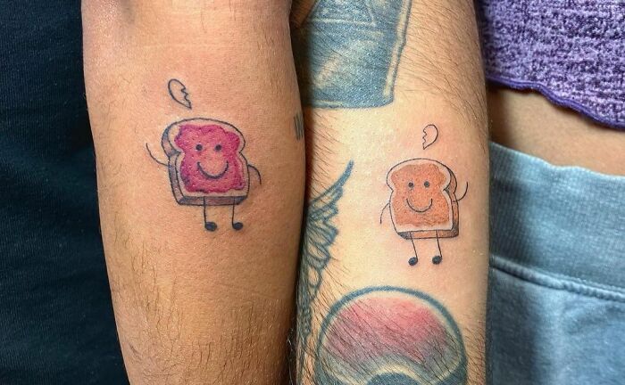 Matching tattoos of smiling toast on arms, perfect for couples or friends expressing a special bond.