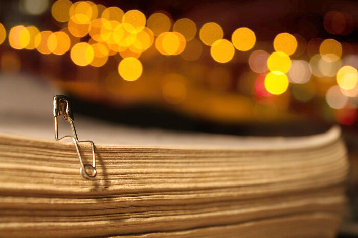 Safety pin sitting on paper stack