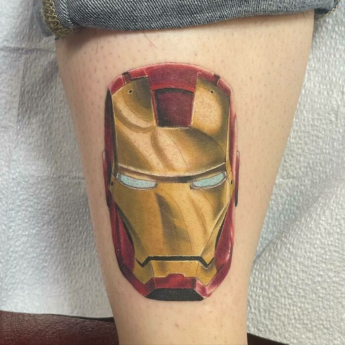Iron Man tattoo on leg, showcasing vibrant colors and detailed design. Marvel tattoo art.