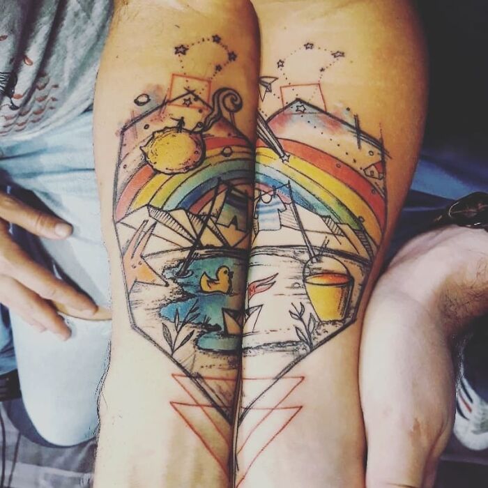 Matching tattoos with colorful rainbow and landscape on arms, perfect for couples or special people in your life.