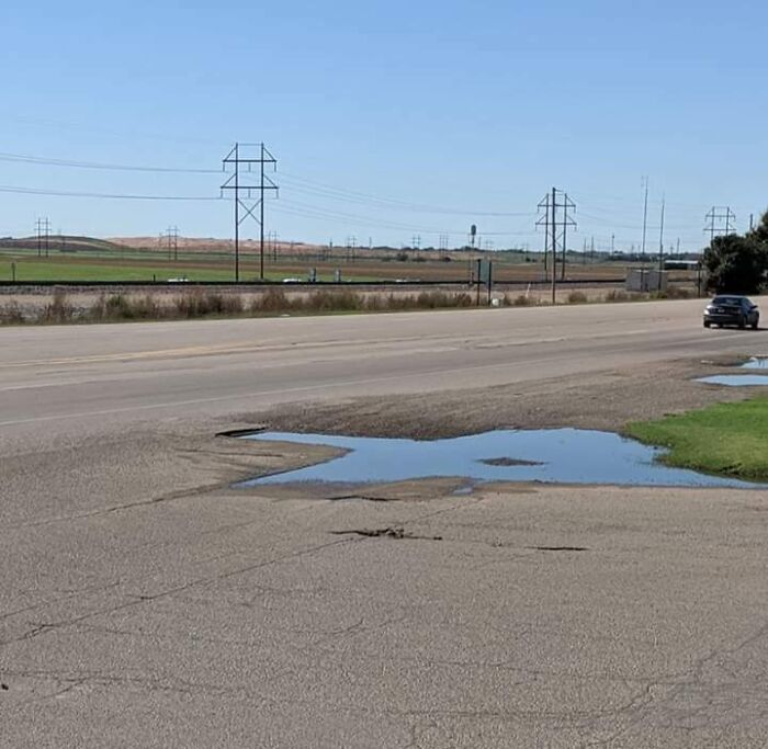 A Texas Shaped Puddle In A Texas Parking Lot