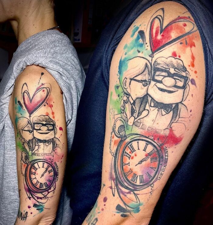 Colorful matching tattoos for couples featuring a loving cartoon couple, heart, and clock design.