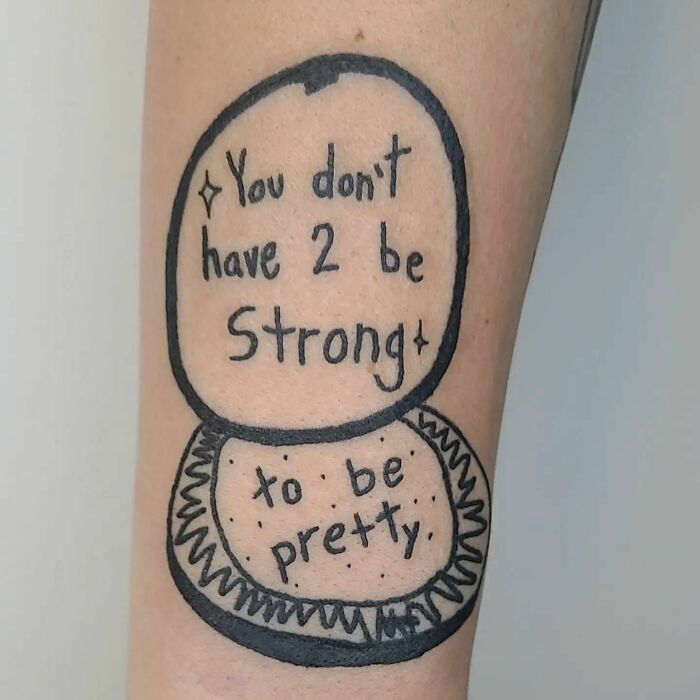 Tattoo with "You don't have 2 be strong to be pretty" inscription celebrating self-love.