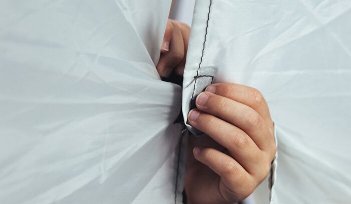 Hands are closing the fabric with Velcro