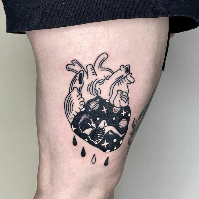 Tattoo of a heart filled with planets and a woman, symbolizing self-love.