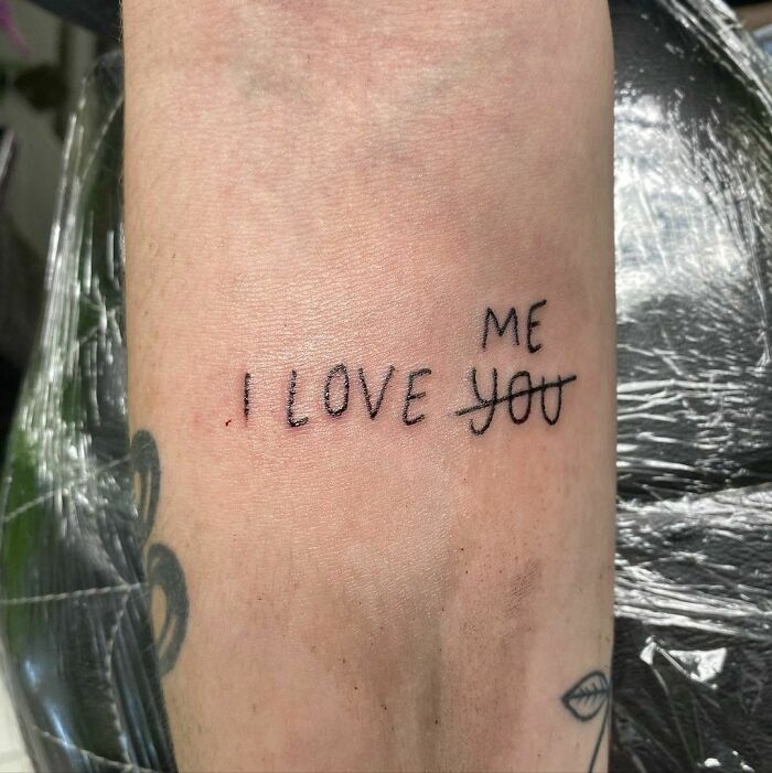 Tattoo on arm with "I love me" representing self-love.