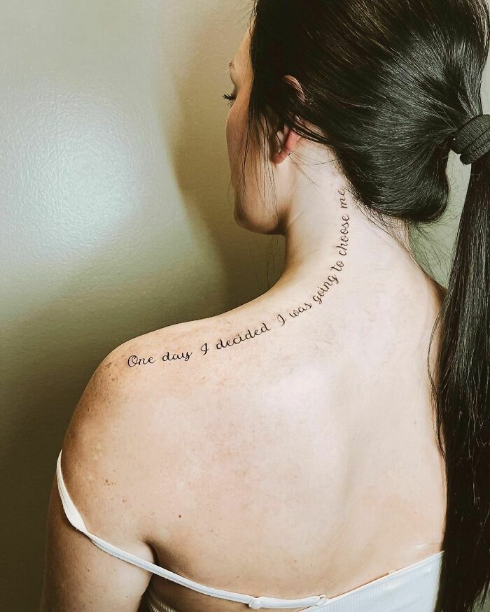 Woman with a "One Day I Decided I Was Going To Choose Me" self-love tattoo on her back and neck.