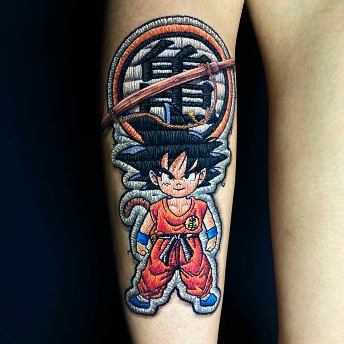 Tattoo of a cartoon character by Eduardo Lozano showcasing a unique 3D embroidery style.