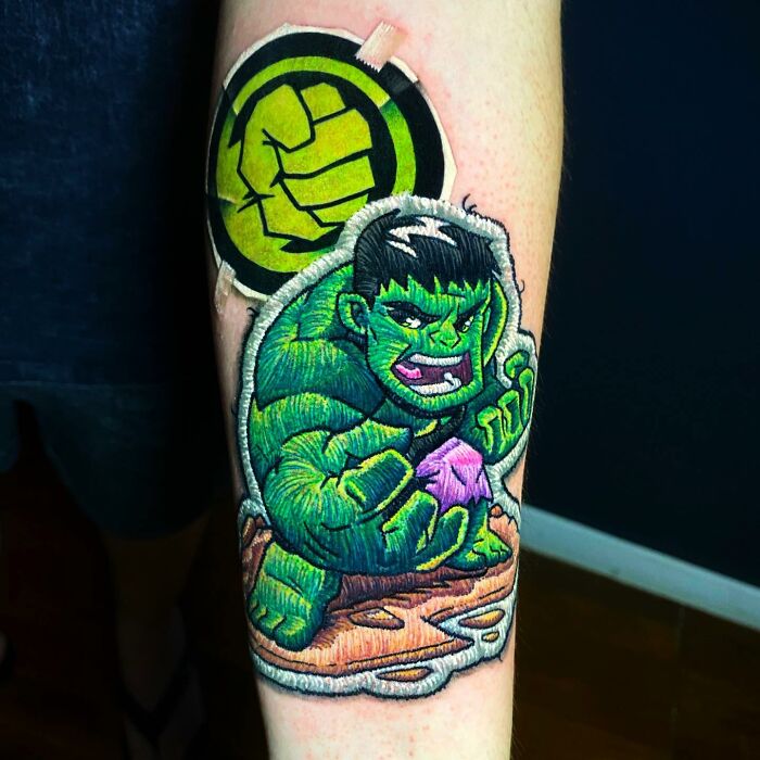 Tattoo by Eduardo Lozano depicting a 3D Hulk embroidery design on forearm.