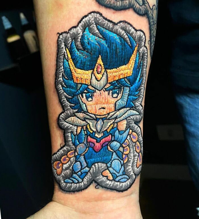 Tattoo by Eduardo Lozano featuring a vibrant anime-style character with blue hair and intricate details.