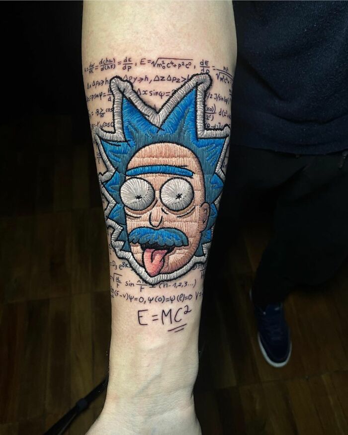 Tattoo on forearm featuring cartoon character with blue hair, showcasing Eduardo Lozano's unique tattooing style.