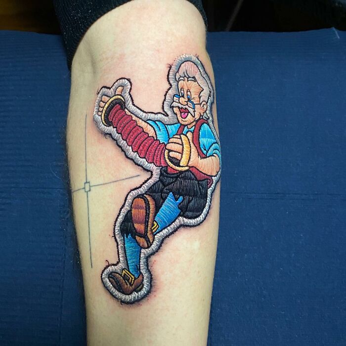 Tattoo by Eduardo Lozano featuring a 3D cartoon character on a forearm, showcasing unique tattooing dimensions.