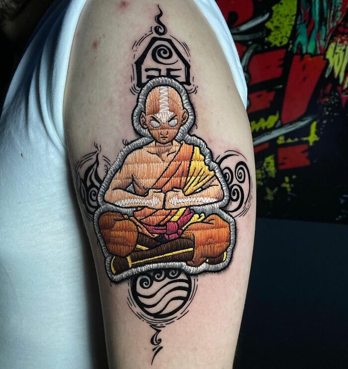 Illustrative tattoo by Eduardo Lozano, featuring a meditating figure in vibrant colors on an arm.