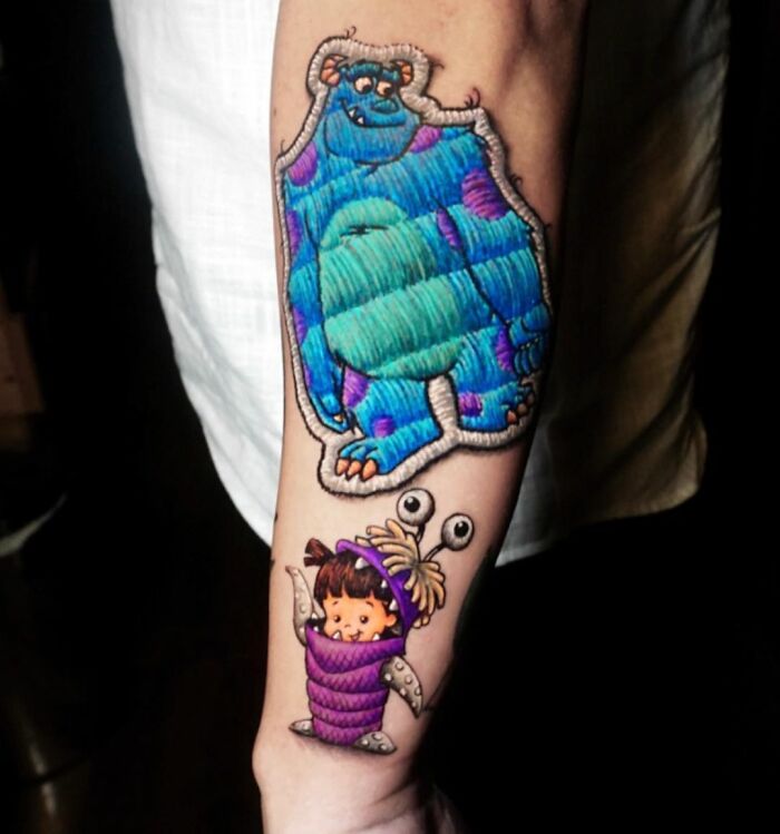 Colorful tattoo on forearm featuring Monsters, Inc. characters, showcasing Eduardo Lozano's unique tattooing dimension.
