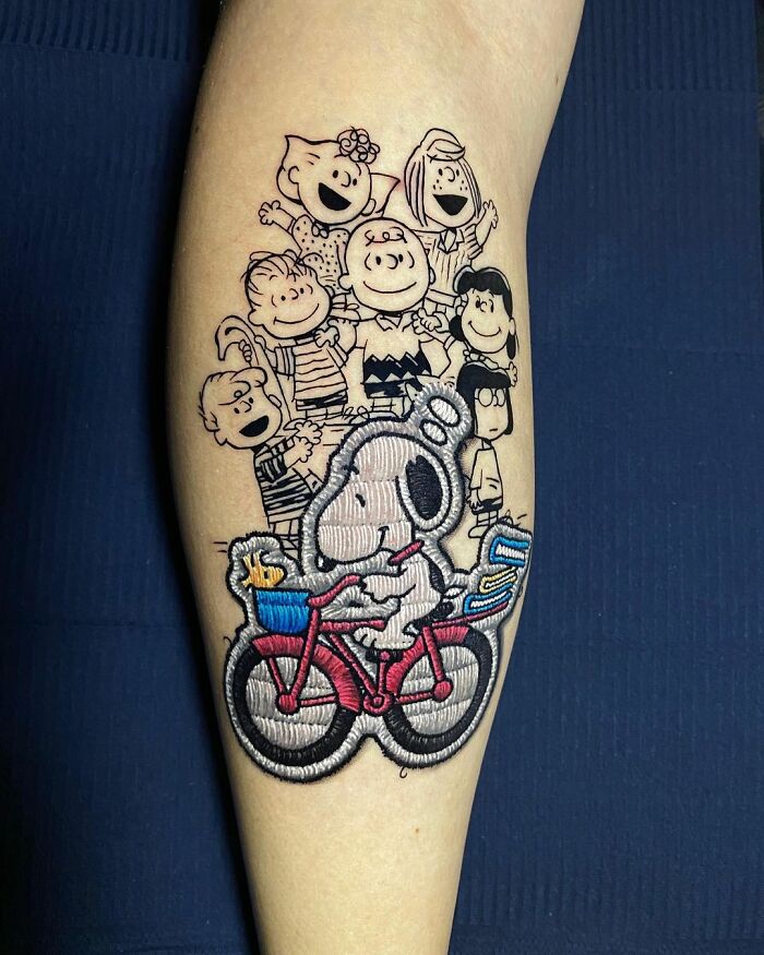 Tattoo featuring cartoon characters in black and color, showcasing Eduardo Lozano's innovative dimension in tattooing.