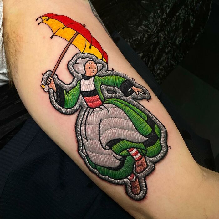 Tattoo art by Eduardo Lozano depicting a vintage style figure with an umbrella, highlighting a new tattoo dimension.
