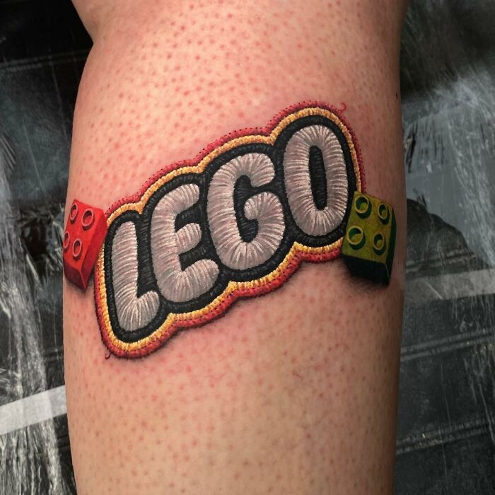 Tattoo by Eduardo Lozano featuring LEGO design with 3D blocks on skin.