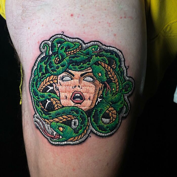 Tattoo of Medusa with green snakes, showcasing Eduardo Lozano's innovative tattooing style.