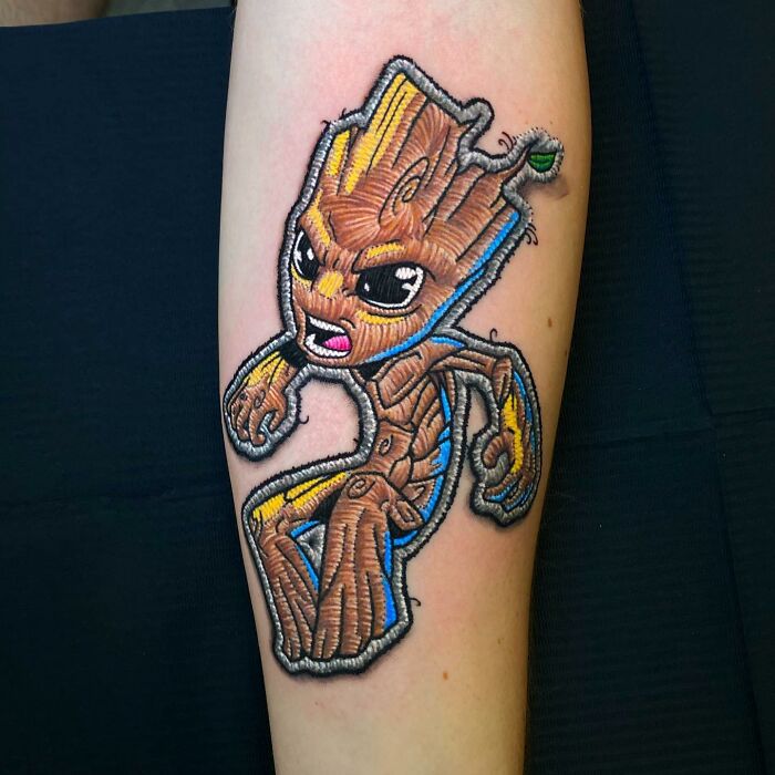 Tattoo of a cartoon character on an arm, showcasing Eduardo Lozano's unique 3D tattooing style.