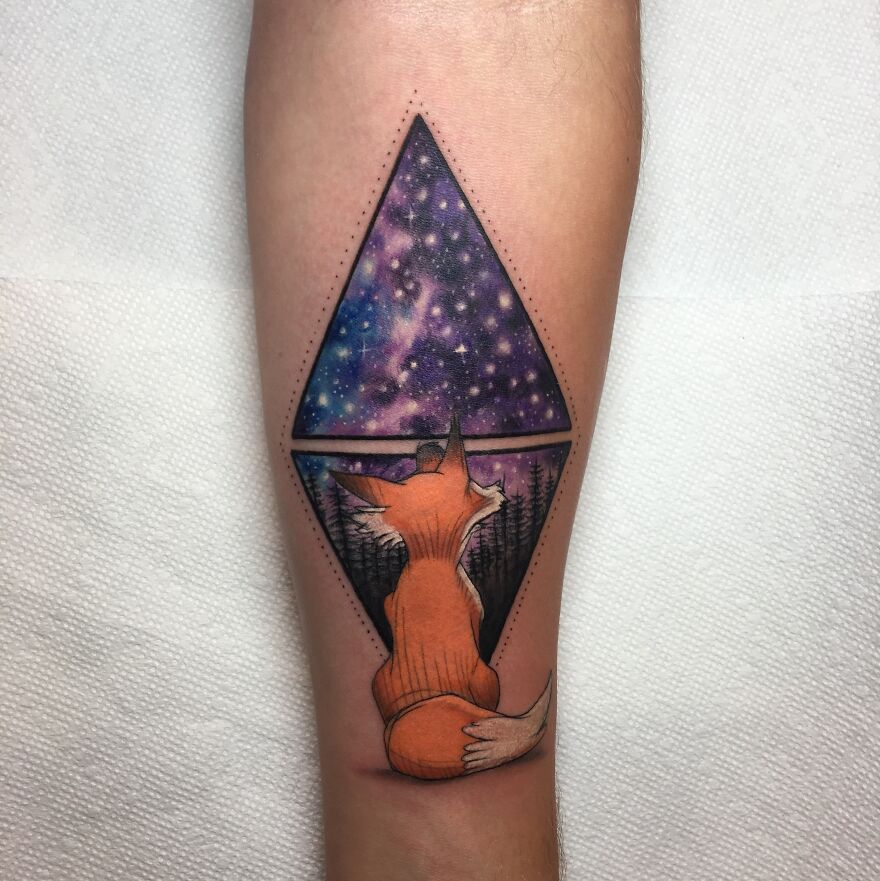 Fox gazing at a cosmic starry sky through a geometric window tattoo, perfect for astrology fans.