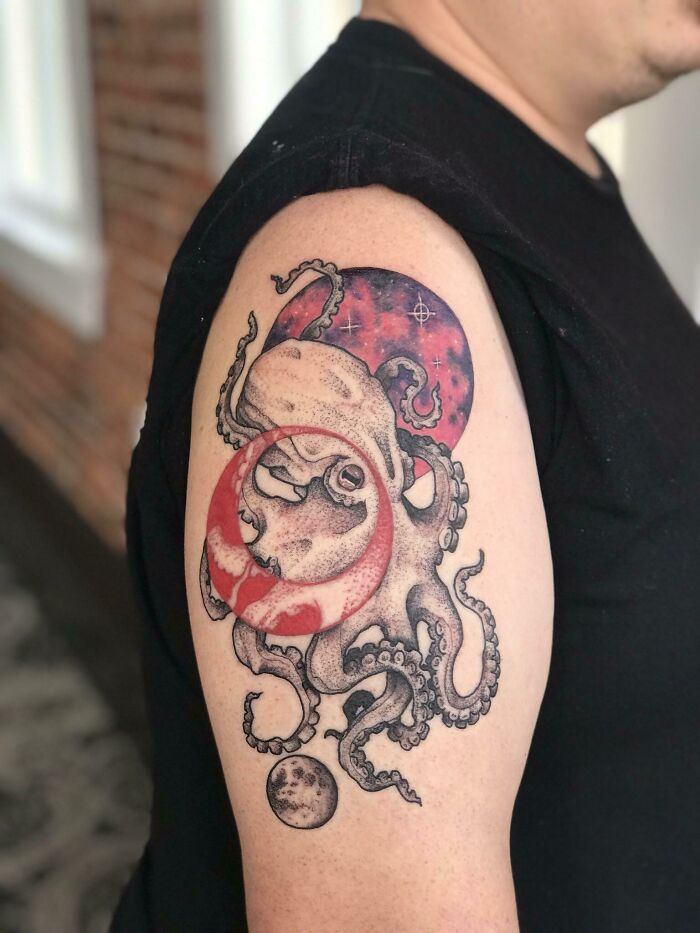 Octopus and moon-themed space tattoo on upper arm, vibrant and detailed design for astrology fans.