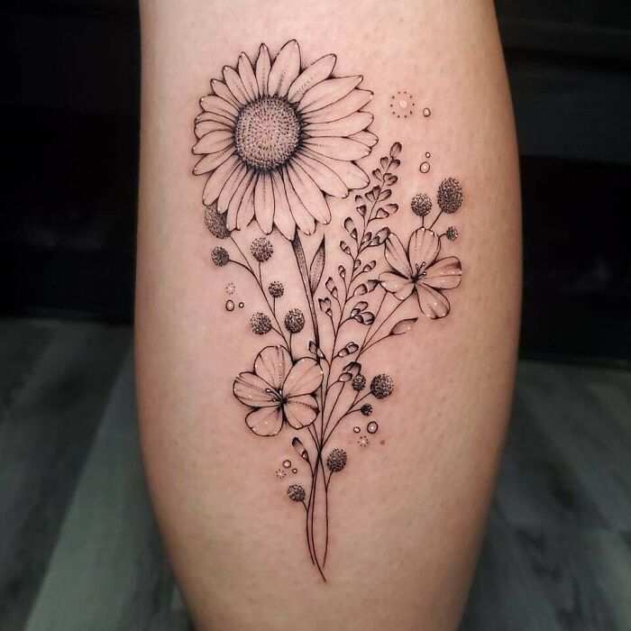Delicate flower tattoo on skin, featuring a blooming design with intricate details.