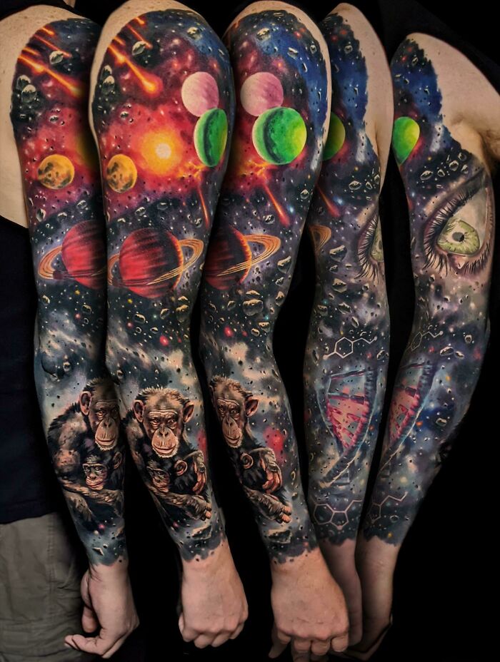 Colorful space tattoos featuring planets, stars, and chimpanzees on a person's arms, perfect for astrology fans.