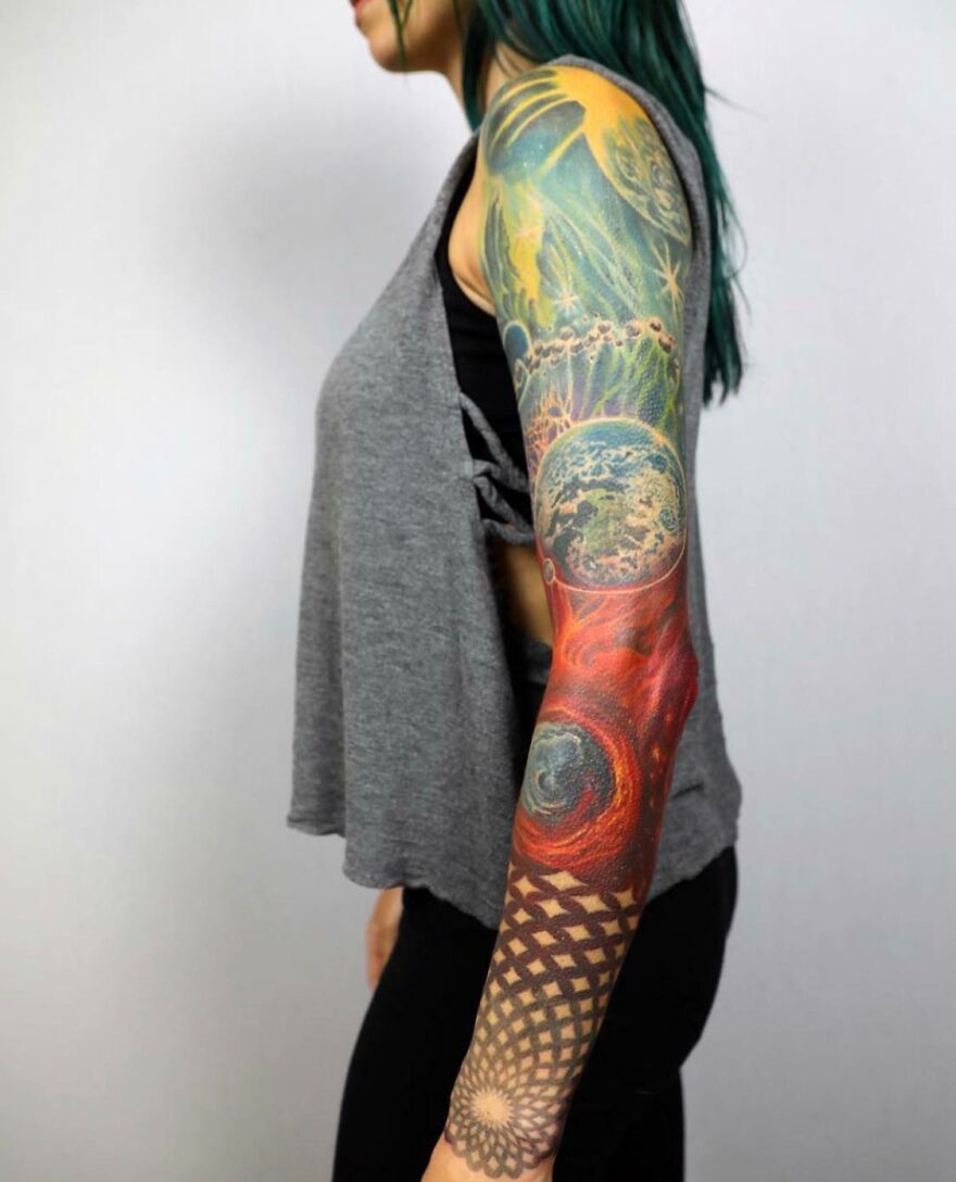 Colorful space tattoo sleeve featuring planets and cosmic designs on a woman's arm.