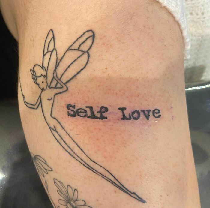Fairy tattoo with "Self Love" text on skin, symbolizing self-love and empowerment.