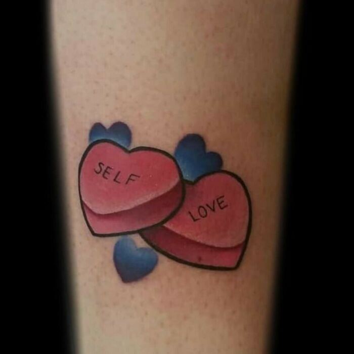 Hearts tattoo with "Self Love" words, emphasizing self-love and personal importance.