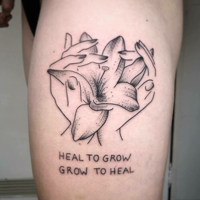 Self-love tattoo of lilies with the phrase "Heal To Grow, Grow To Heal" on skin.