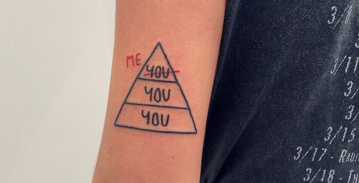 Self-love tattoo of a pyramid with "Me" at the top and "You" below on an arm.
