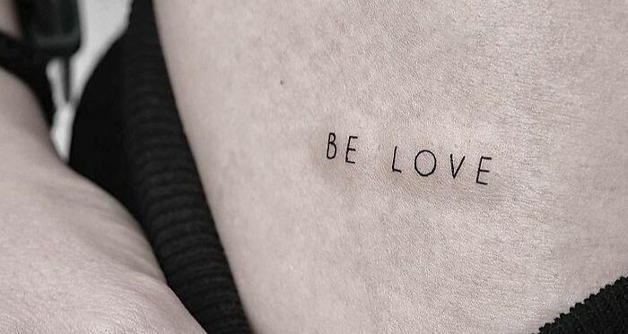 "Be Love" self-love tattoo on skin, celebrating personal importance and positivity.