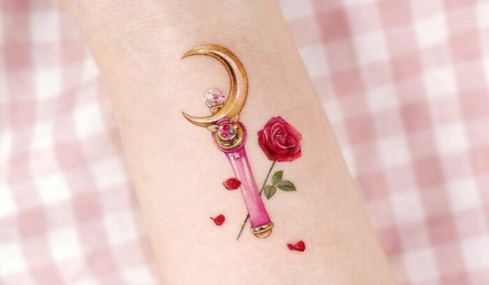 Self-love tattoo featuring a princess wand with a rose, symbolizing empowerment and beauty.