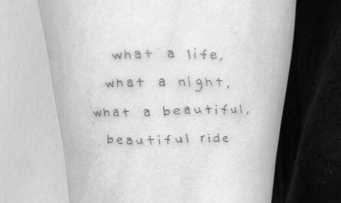Tattoo with the phrase "What a life, what a night, what a beautiful, beautiful ride," celebrating self-love.