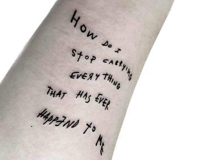 Tattoo on forearm with handwritten phrase, symbolizing self-love and empowerment.